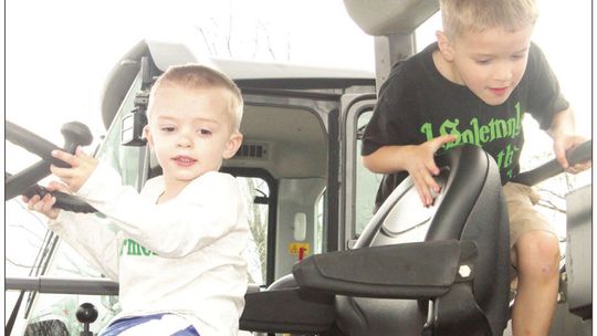 David Crockett, 6, gets into the driver’s seat of tractor at the Truck Petting Zoo in Taylor March 17, 2022 while Michael Crockett, 2, also occupies the vehicle. Photos by Fernando Castro