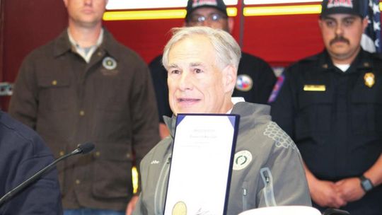 Gov. Greg Abbott shows the disaster declaration in response to Texas tornadoes during a press conference in Elgin March 23. Photo by Fernando Castro