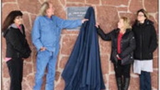 Members of the parks advisory board unveil the dedication plaque honoring Adam Orgain. Left to right: Rose McMillin (former member), Perry Savard, Sharon Dyer and Charlotte Tyre.