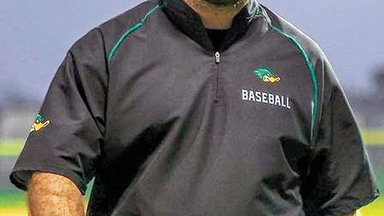 Taylor High School varsity baseball head coach Justin Adams walks off the field on April 4 during the Ducks’ 7-2 home victory over district foe La Grange High School. Photo by Ryan Newsom