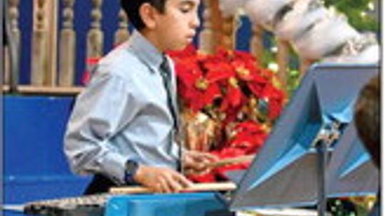 Sixth grader, Diego Reyes plays percussion during the St. Mary’s Instrument Christmas Concert.