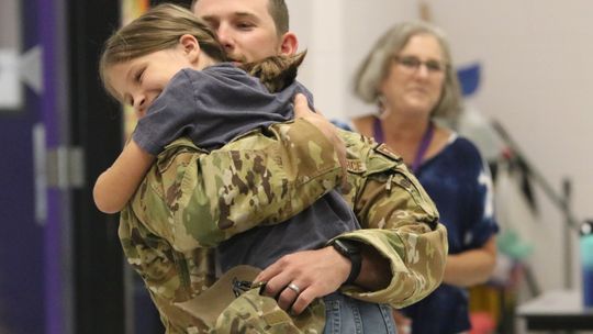 Adilene Saunders, a fourth grader at Thrall Elementary, gets a surprise visit during lunch from her father, Air Force Technical Sergeant Caleb Saunders, who returned home for a weekend visit during his year-long deployment. He also surprised his thirdgrade daughter, Gracelynn, and Jolene w...