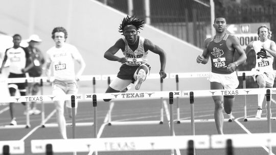 Taylor High School senior boys track and field standout Jarvis Anderson clears a hurdle on May 11 en route to a gold medal in the 300-meter hurdles at the UIL 4A State Track and Field Tournament held at Mike A. Myers Stadium in Austin. Photo by Briley Mitchell