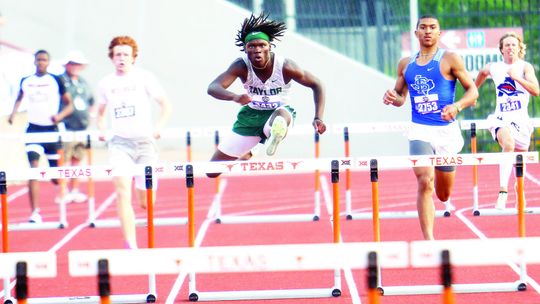 Taylor senior Jarvis Anderson clears a hurdle and increases his lead in the 4A boys’ 300-meter hurdles state finals in Austin on Thursday. Photos by Briley Mitchell