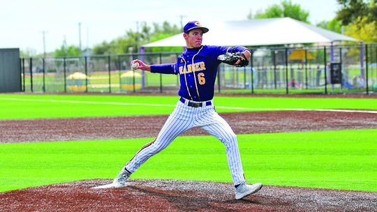 Lions senior Travis Burton delivering a strike to the Thrall batter. Photo by Larry Pelchat