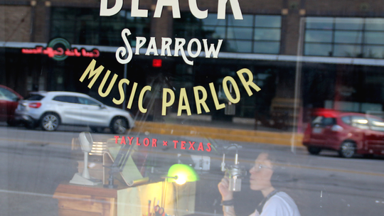 Black Sparrow owner Shannon Bagent records at the KBSR headquarters. Photo by Jason Hennington