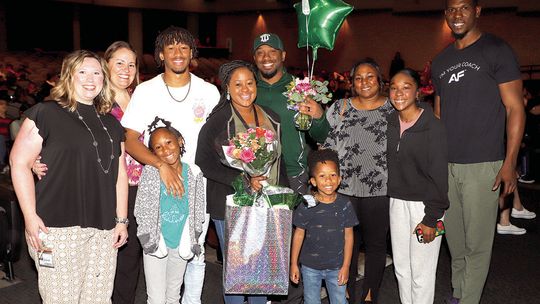 Main Street Intermediate School’s Teacher of the Year, Iris Bunton, is surrounded by family members and campus administrators. Photo by Tim Crow