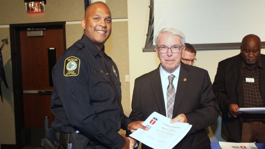 Raymond Anderson, of the Taylor Police Department, receives congratulations from Jim Yeonopolus, Central Texas College chancellor, during the Central Texas College Police Academy graduation ceremony earlier this summer.   Courtesy photo