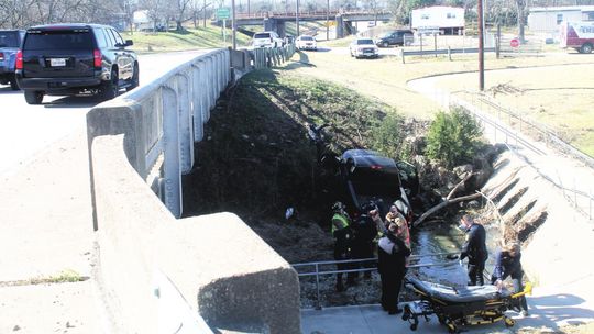 First responders help an injured driver from a vehicle in a ditch underneath Fourth Street and near the City of Taylor Animal Shelter Jan. 6. Photos by Fernando Castro