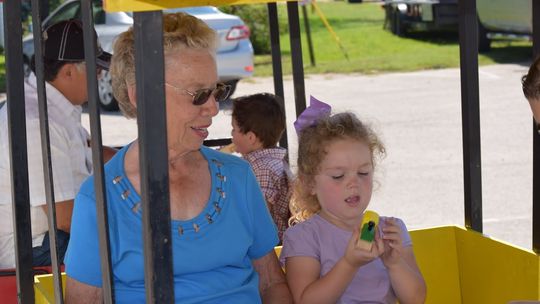 At a past Choo Choo Fest, Coupland City Secretary LaVerne Rohlack and her granddaughter Amelia Cotterill enjoy riding the Kiddie Express Train. Photo by Kyle Hensley