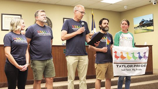 Taylor Pride board members Denise Rodgers, Patrick Taylor, Ben Morgan and Trisha Lewis surround Mayor Brandt Rydell (middle) as he reads the Pride Day proclamation. Photo by Edie Zuvanich