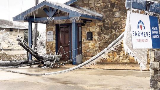 A damaged utility pole lies in front of the Farmer’s Insurance building Feb. 2 at 503 Mallard Ln. Photo by Ann Miller