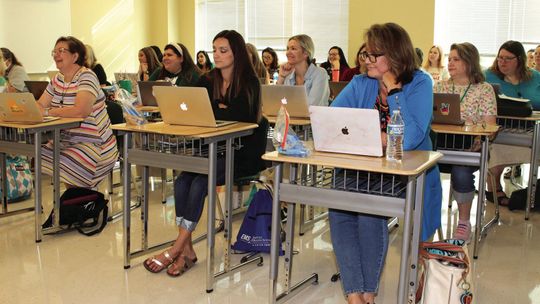 Taylor educators are all smiles as they begin professional development sessions to prepare for a successful year. Photo by Tim Crow