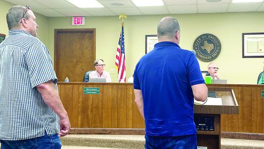 (From left) Mike Hickey, the senior project manager of the broadband division for Mears, and John Fetter, ISP market manager with Fiber First, answer questions from the City Council at the regular meeting June 22. Photo by Nicole Lessin