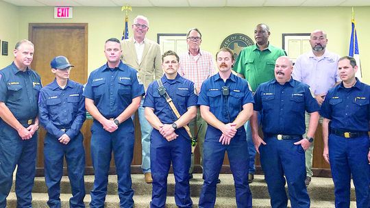 Chief Daniel Baum (right) talks about the heroic efforts of Taylor Fire Department firefighters who worked as a team to complete a dramatic ladder rescue and extinguish a dangerous fire at the Burnett Place Apartments June 5, including Assistant Chief Robert Copeland (left), Lt. Eric Engel...