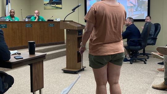 Stacy Stork, a member of a citizens compensation committee, protests the City Council’s split vote to increase their own pay to $1,000 per month and $1,500 for the mayor at the regular meeting July 27.  Photo by Nicole Lessin