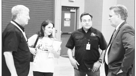 Members of the Austin Disaster Relief Network (from left) Jim Maunder, Gina Maunder and Robert Vidaurri visit with Williamson County Judge Bill Gravell at the MARC Center Tuesday afternoon. Photo by Jason Hennington