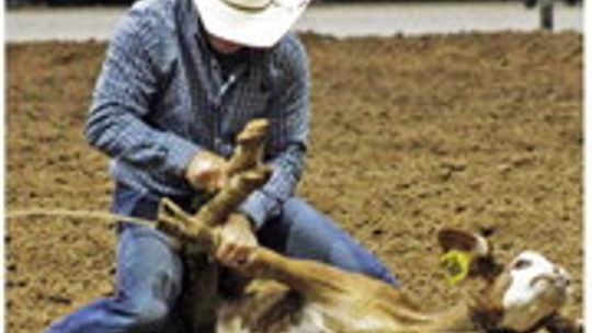 A competitor ropes a calf for a rodeo event last year at the Williamson County Expo Center. Photo by Matt Hooks