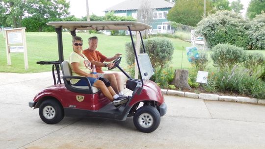 CCO Assistant Treasurer Becky Sutton and Coupland Mayor Jack Piper start out to observe the play at a previous CCO golf tournament. This year’s will be Aug. 6. Photo by Susan Garry