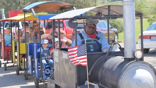 Owner and driver JC Callis drives families around Coupland on the Kiddie Express Train at a past Choo Choo Fest. Photo by Susan Garry