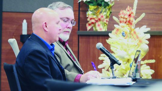 Director of parks and recreation, Jeff White (front) and city manager James Earp listen to city council’s concerns over the concrete contract. Courtesy photo