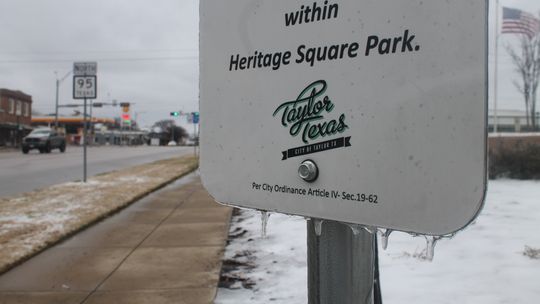 A sign on Heritage Square in Taylor drips with ice Feb. 4. Photo by Fernando Castro