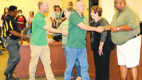 Carl Caldwell (left), soccer coach John Brockway (middle) and Dan Dixon are greeted with thanks and appreciation from the Taylor School Board for their quick actions and efforts in keeping the boys soccer team safe in their travels to a recent game. Photos by Tim Crow