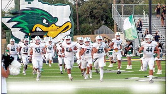 The Taylor High School varsity football team runs onto the field on Aug. 25 prior to the Ducks’ seasonopening road game at Gatesville High School. Photo by Andrew Salmi