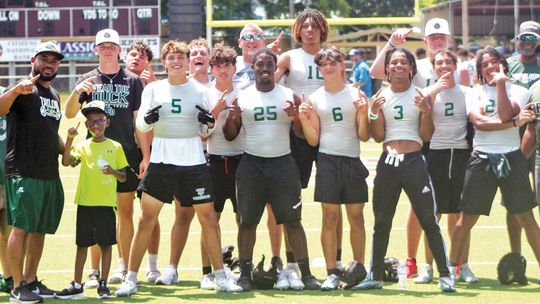 Members of the Taylor High School varsity football team and coaches celebrate on Saturday, June 10 after defeating Yoakum High School 20-19 at Yoe Field in Cameron following a 7-on-7 state qualifying tournament. Photos by Andrew Salmi