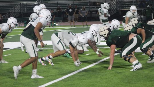 The Ducks' front seven gets ready for the snap on Aug. 17 during Taylor's scrimmage against Franklin at Hedrick Field. Photo by Andrew Salmi