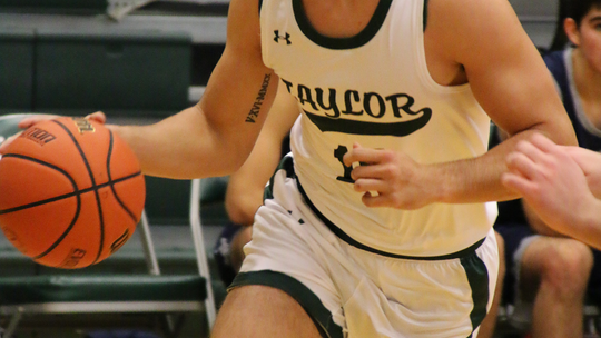 Ducks senior Conner Cobb driving towards the basket looking for a layup. Photo by Larry Pelchat