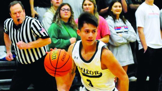 Ducks senior Landon Velasquez dribbling the ball up the court on a fast break. Photo by Larry Pelchat