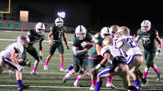 Ducks win first district game in four years. They defeated Marble Falls at the Duck Pond Friday night. Ducks’ junior Jackson Meller puts two hands on the football and braces to run through tackles from Marble Falls defenders. Photos by Larry Pelchat