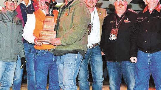 Sean Leschber (middle), Twisted L headmaster, celebrates winning overall grand champion in the 2022 World’s Championship Bar-B-Que Contest at the Houston Livestsock Show and Rodeo Feb. 26 alongside HSLSR officials.