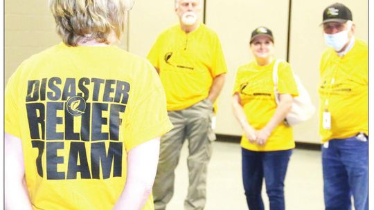 ADRN volunteers have a brief meeting and discuss how to help serve the needs of residents who have been impacted by last week’s storms. Photos by Jason Hennington