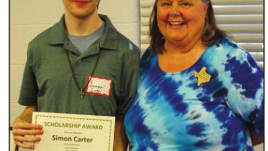 Hutto High School graduating senior Simon Carter accepts the $1,000 WCRTA Aspiring Educator Scholarship from Melissa Jones. Photo by Barbara Yerby