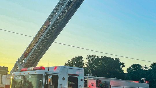 The American waves in the air of downtown Taylor as first responders line up to march in remembrance of the tragic events of Sept. 11, 2001. Photo by Fernando Castro