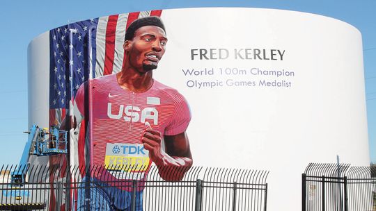 Fred Kerley’s mural being painted by local artist Adam Davenport at 1606 Main St. Photo by Nicole Lessin