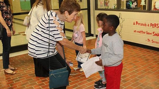 King Mathis greets Taylor ISD Ambassador Jo Lindquist as she arrives at T. H. Johnson Elementary School.