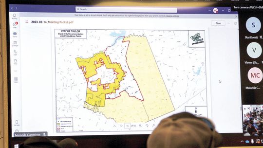 At the Feb. 14 meeting of the Williamson County Emergency Services District No. 10 Board, commissioners look at a map of a boot-shaped portion of Taylor’s Extraterritorial Jurisdiction for annexation, which was recently approved by voters. Photo by Nicole Lessin