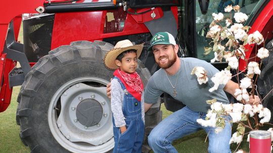 Future farmer, Andres Gonzales Huerta, visits with Taylor farmer, Tyler Jaecks, about growing corn and cotton. Photo by Tim Crow