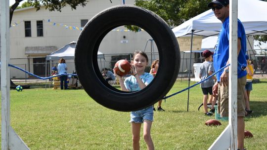 Students put their arm to the test with the quarterback challenge booth at the St. Mary’s Fall Festival Homecoming. Photos courtesy of St. Mary’s Catholic School