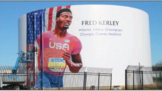 Fred Kerley’s mural being painted by local artist Adam Davenport at 1606 Main St. Photo by Nicole Lessin