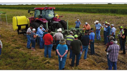 Farmers discuss Stiles Farm Field Day topics during a previous event. Texas A&amp;M AgirlLife / Blair Fannin