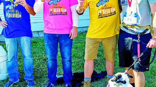 Race organizer Scott Dean, commander of the American Legion Graham D. Luhn Post 39 in Taylor, visits with Matthew Drummond, Ned Rhoades Jr., and Jace Gilbreath Nov. 5 at the after party. Photos by Nicole Lessin