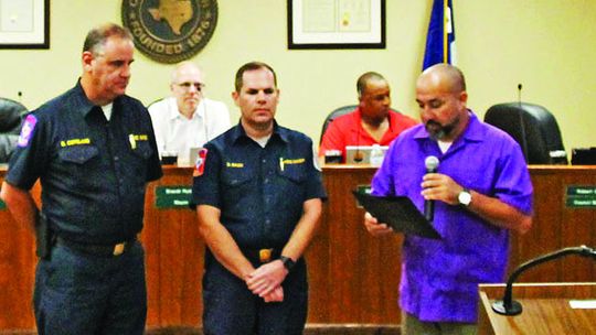 Councilman Robert Garcia reads the proclamation for Fire Prevention Week at the Sept. 22 council meeting to Fire Chief Daniel Baum and Assistant Chief Bobby Copeland.