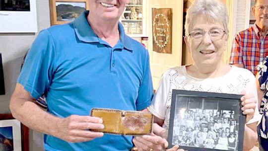 Tim Kennedy shows Lois Luedtke his original childhood wallet. Photo courtesy of Suzanne Thoele