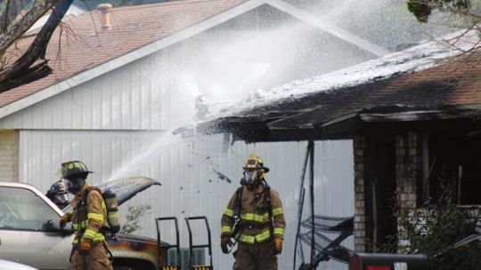 Firefighters work the end of a structure fire in Taylor June 16. Photo by Matt Hooks