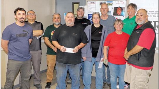 Gemini employees present checks totaling $1,750 to Taylor ISD Family Support Services Coordinator, John Matthews. Pictured are Oscar Cellussi, Nick Ochoa, Mark LeBlanc, Jason Faykus, Kristina Lackland, David Rorex, Brenda Valdez, John Rorex, Lee Perez and John Matthews. Photo by Tim Crow