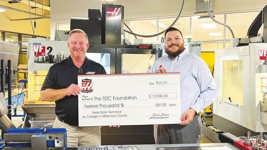 Michael Smith, The TSTC Foundation’s vice president of development, right, accepts a check for $12,000 from a Haas Foundation representative recently at TSTC’s campus in East Williamson County. Photo courtesy of TSTC